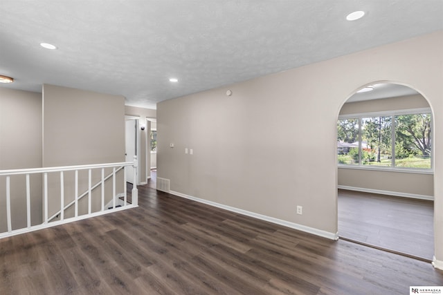 unfurnished room featuring dark hardwood / wood-style flooring