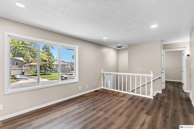 empty room with dark hardwood / wood-style floors