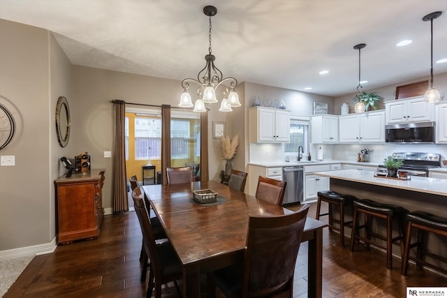 dining space featuring a chandelier, dark hardwood / wood-style floors, and sink