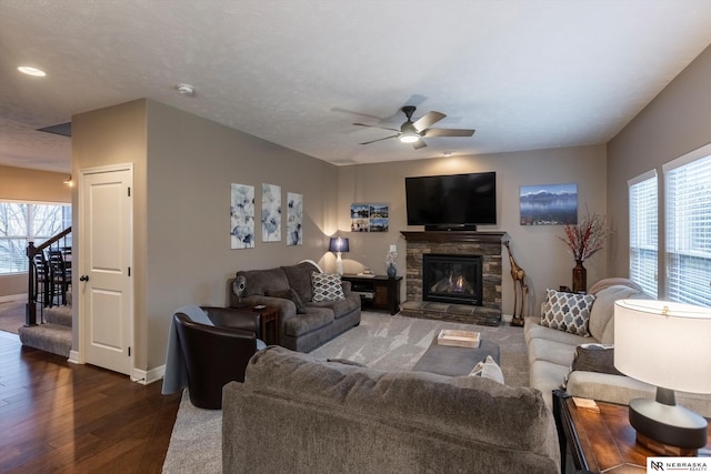 living room with ceiling fan, dark hardwood / wood-style floors, and a fireplace