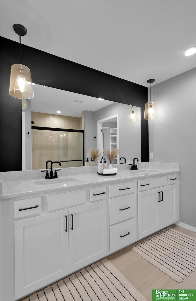 bathroom with vanity and a shower with shower door