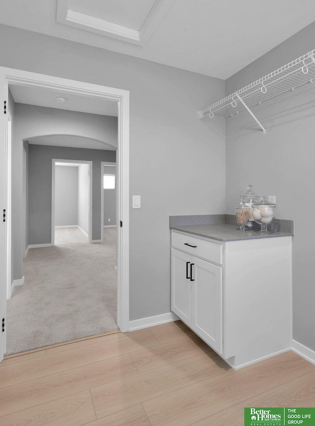 laundry room featuring light colored carpet