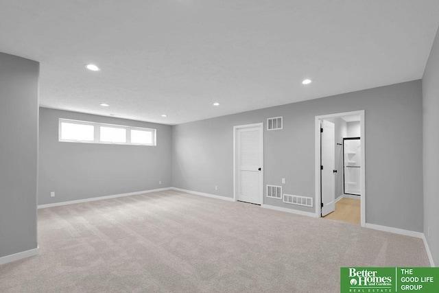 basement featuring light colored carpet