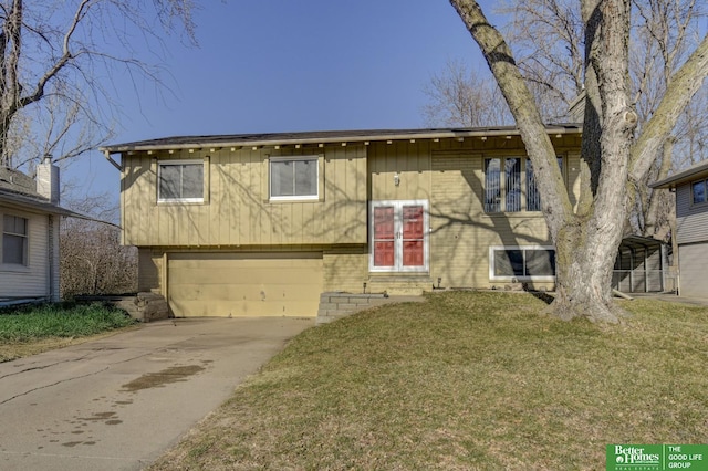 split foyer home featuring a front yard and a garage