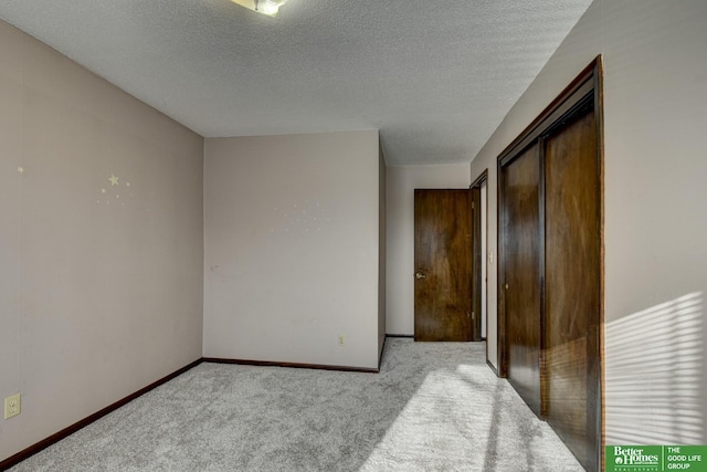 carpeted spare room with a textured ceiling