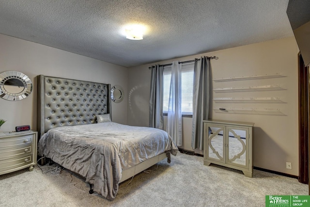 bedroom featuring carpet flooring and a textured ceiling