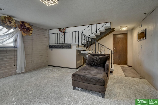 living area with light colored carpet and a textured ceiling