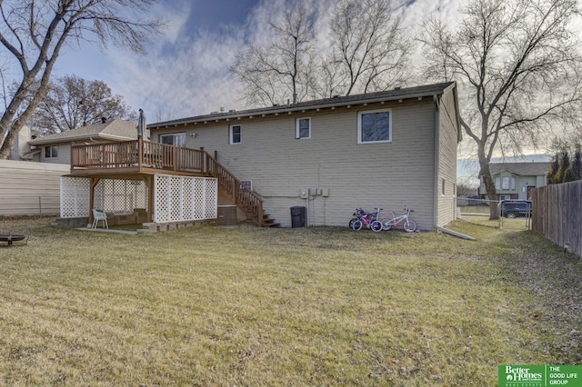 rear view of property with a lawn and a wooden deck