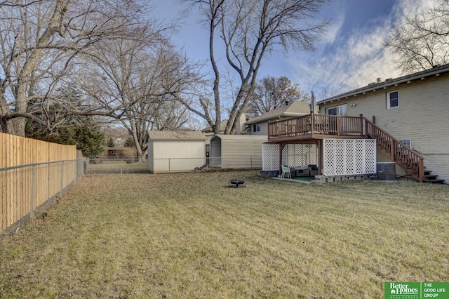 view of yard with central AC unit, a deck, and a storage unit