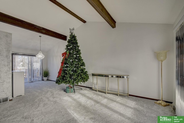 carpeted spare room featuring beam ceiling and high vaulted ceiling