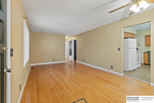 empty room featuring ceiling fan and light hardwood / wood-style floors