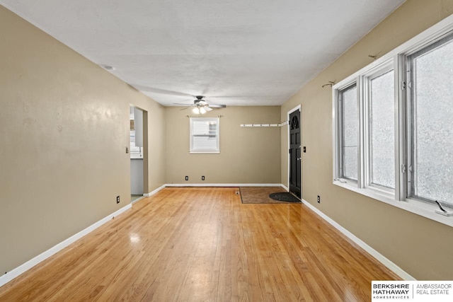 unfurnished room with ceiling fan, plenty of natural light, and light hardwood / wood-style floors