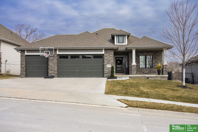 prairie-style home featuring a front yard and a garage