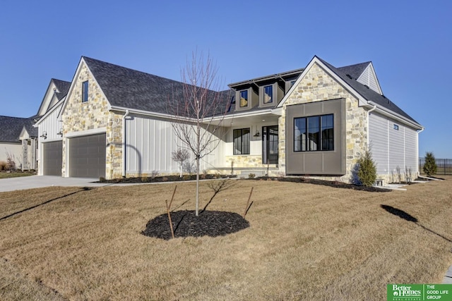 view of front of home with a garage, a porch, and a front yard