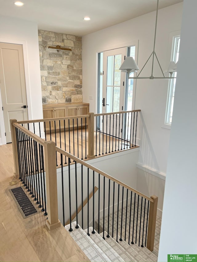 staircase featuring hardwood / wood-style flooring and a healthy amount of sunlight