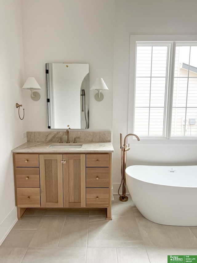 bathroom featuring tile patterned flooring, vanity, and a bath