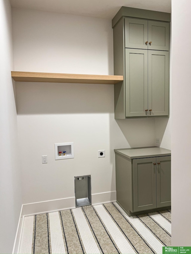 clothes washing area with electric dryer hookup, cabinets, and hookup for a washing machine