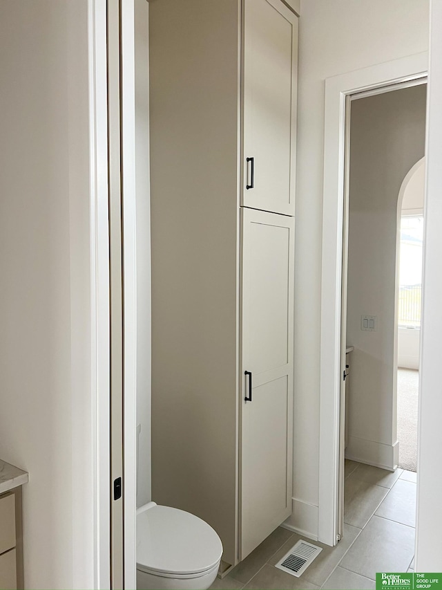 bathroom with tile patterned floors and toilet