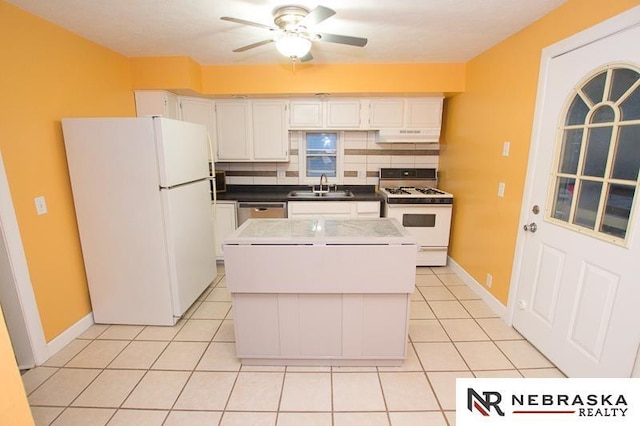 kitchen featuring a center island, white appliances, sink, tasteful backsplash, and white cabinetry