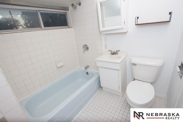 full bathroom featuring tile patterned flooring, vanity, toilet, and tiled shower / bath