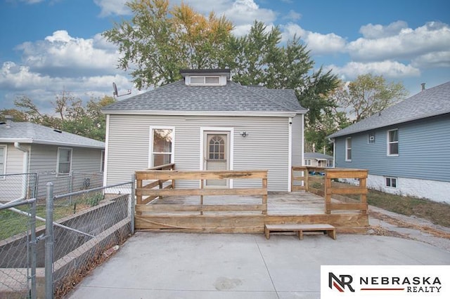 rear view of property featuring a deck