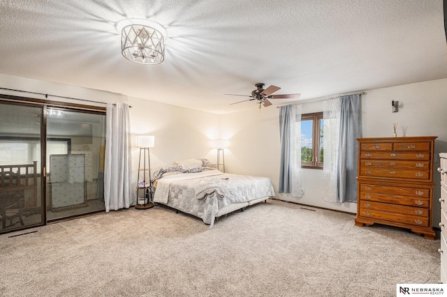 bedroom with carpet flooring, ceiling fan, and a textured ceiling