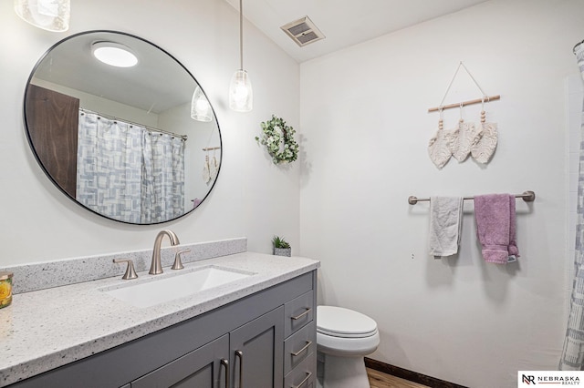 bathroom featuring hardwood / wood-style flooring, vanity, and toilet