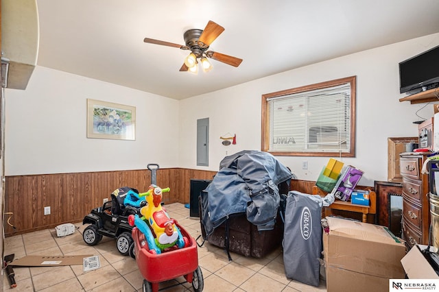 interior space featuring electric panel, ceiling fan, and light tile patterned floors