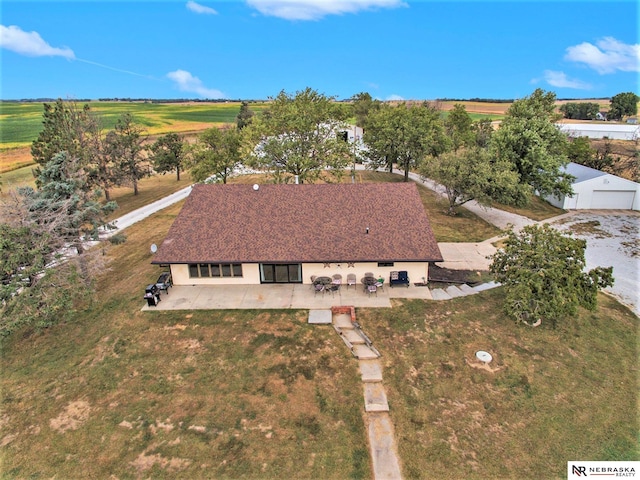 birds eye view of property with a rural view