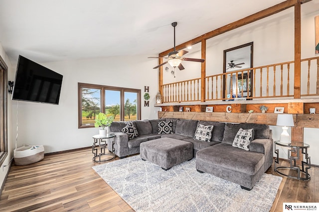 living room with ceiling fan, high vaulted ceiling, and hardwood / wood-style flooring