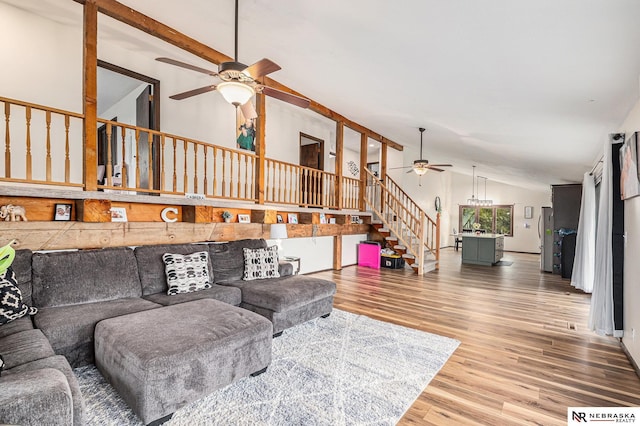 living room with hardwood / wood-style floors, vaulted ceiling with beams, and ceiling fan