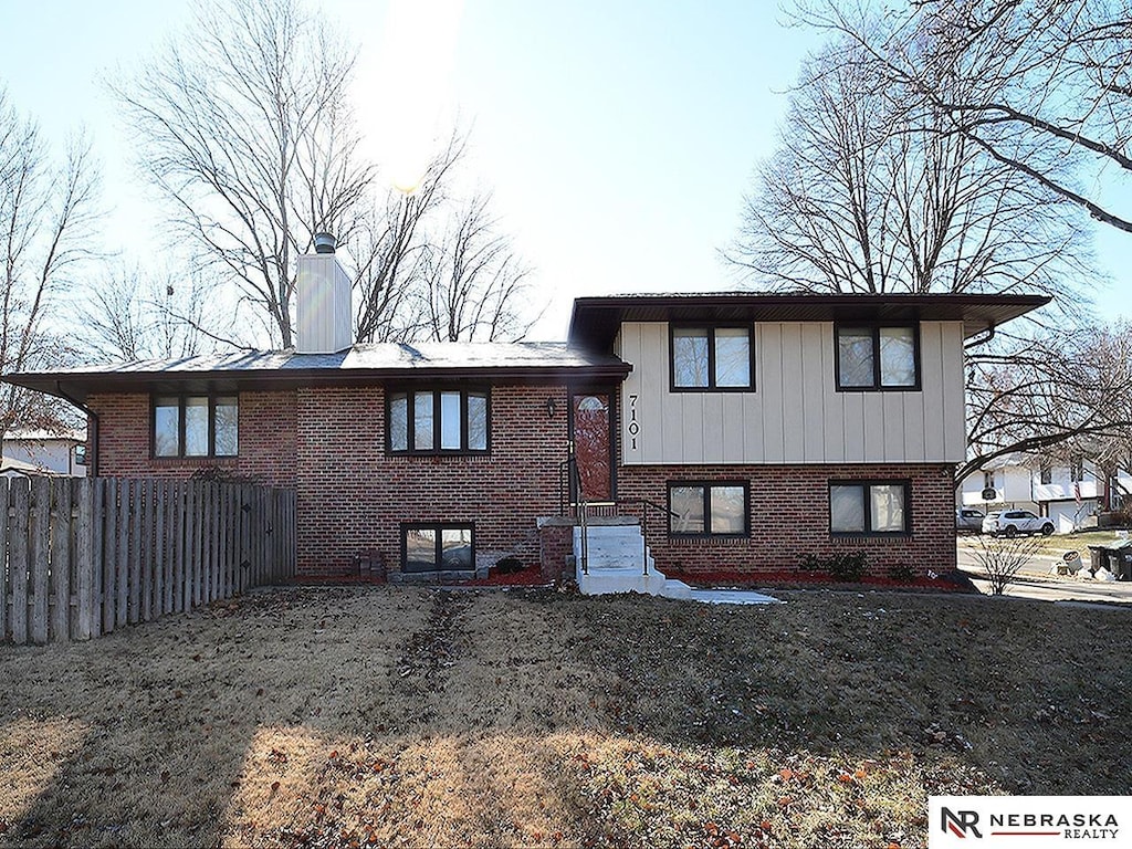 back of property featuring a lawn