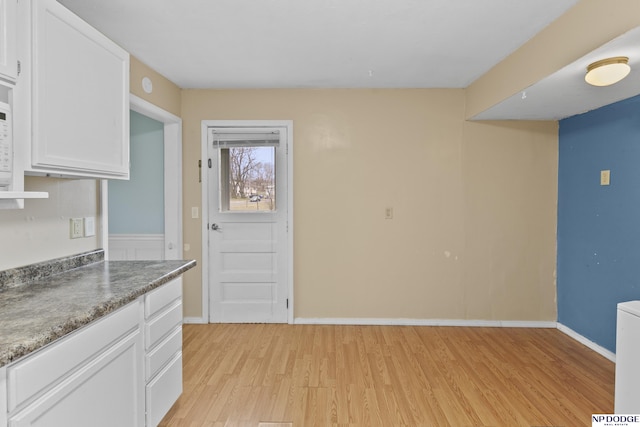 kitchen featuring white cabinets and light hardwood / wood-style floors