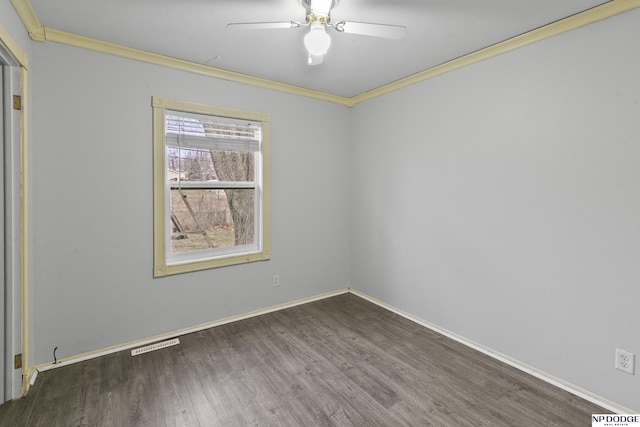 spare room featuring dark hardwood / wood-style flooring, ceiling fan, and crown molding