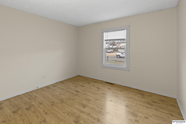 unfurnished room with light hardwood / wood-style floors