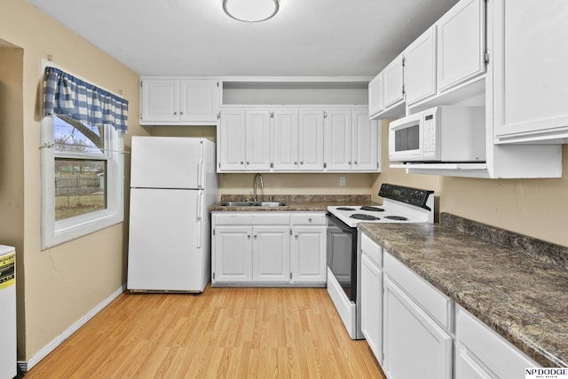 kitchen with white cabinets, white appliances, and sink