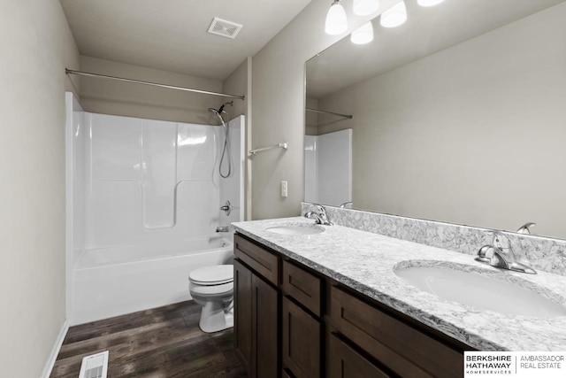 full bathroom featuring vanity, toilet, wood-type flooring, and bathtub / shower combination