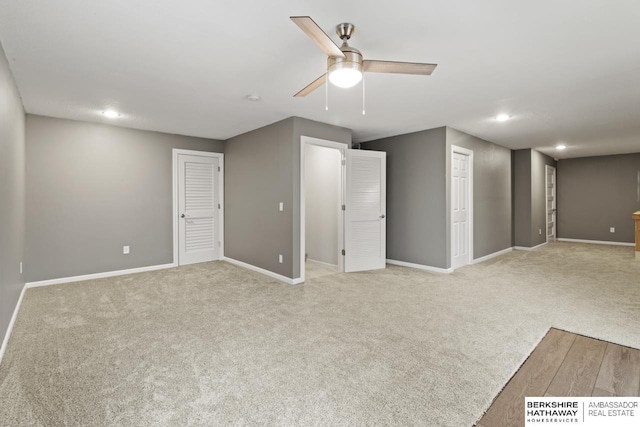 interior space featuring ceiling fan and light carpet