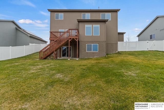 back of house with a yard and a wooden deck