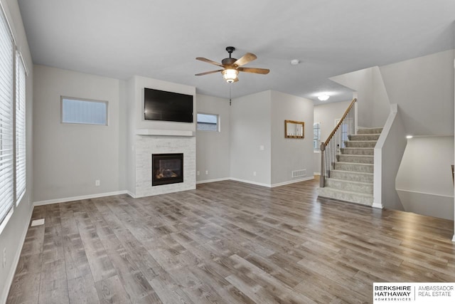 unfurnished living room with ceiling fan, light hardwood / wood-style floors, and a wealth of natural light