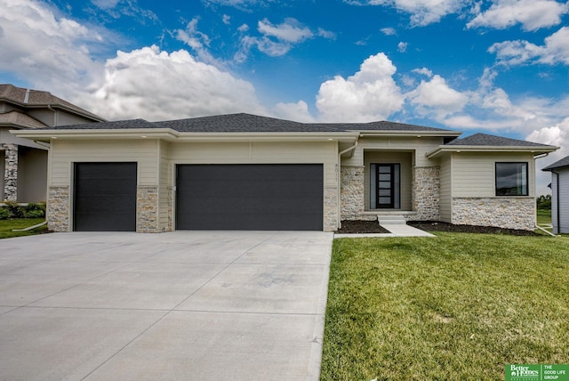 prairie-style house with a front yard and a garage