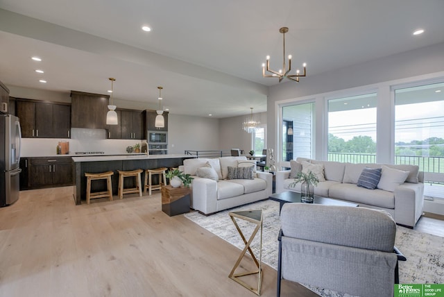 living room featuring light hardwood / wood-style floors and an inviting chandelier