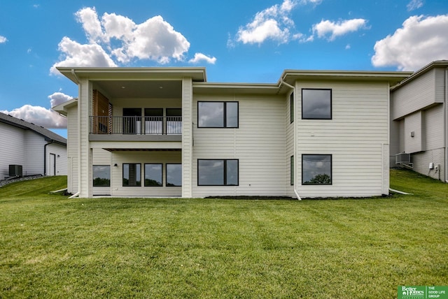 rear view of property with a yard, a balcony, and central AC unit