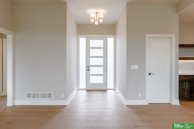 foyer featuring plenty of natural light and light hardwood / wood-style floors