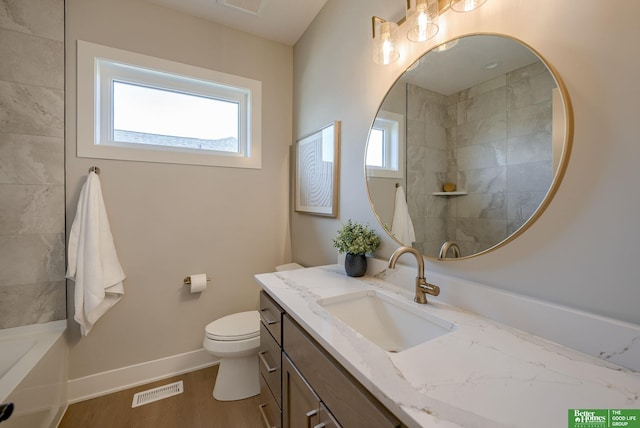 bathroom featuring hardwood / wood-style floors, vanity, and toilet