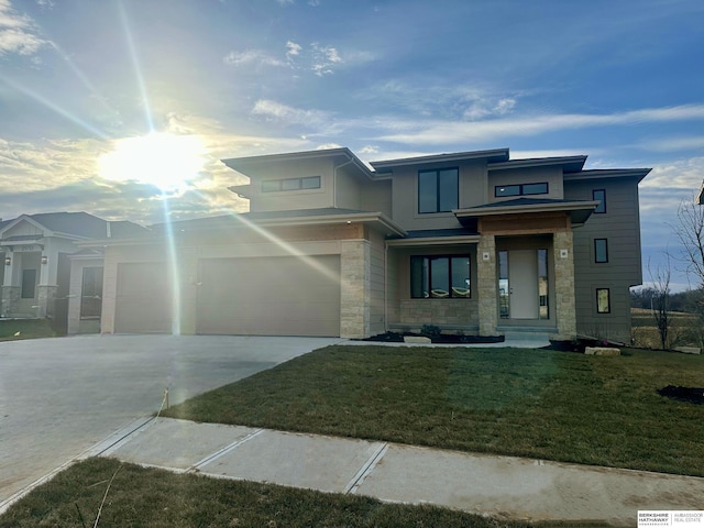 view of front of house featuring a front yard and a garage