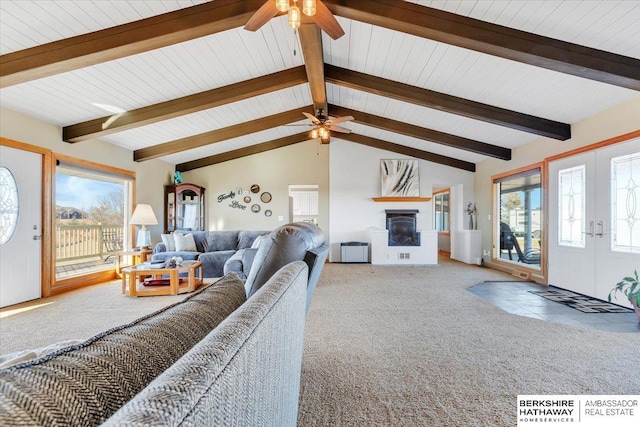 living room featuring lofted ceiling with beams, ceiling fan, wooden ceiling, and carpet floors