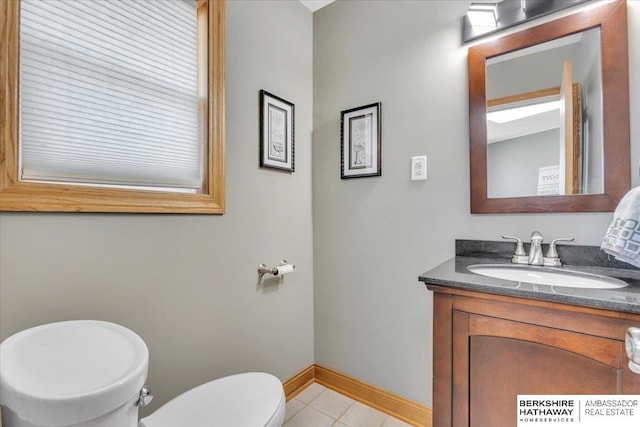 bathroom with tile patterned flooring, vanity, and toilet