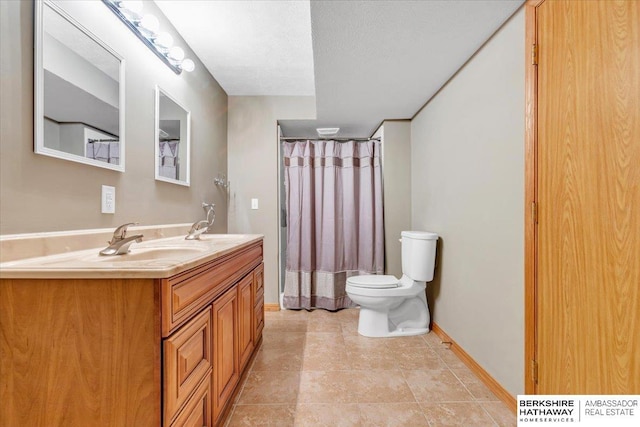 bathroom with vanity, a textured ceiling, and toilet