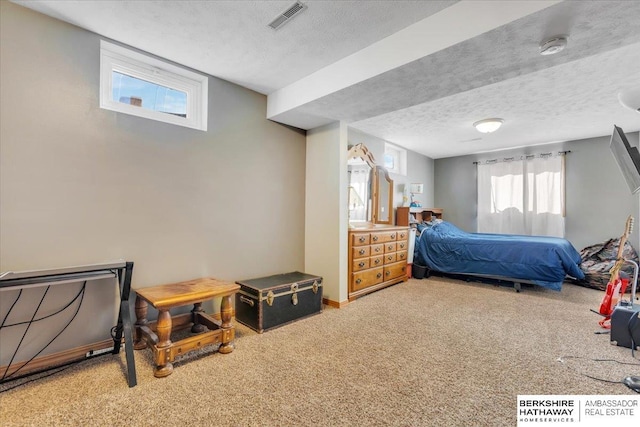 carpeted bedroom with a textured ceiling